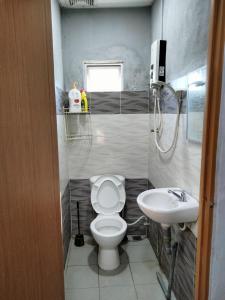 a bathroom with a toilet and a sink at Hotel Bajet DNOOR Kota Bharu in Kota Bharu