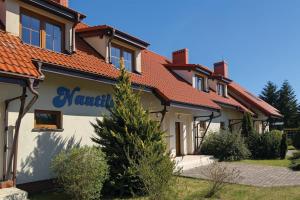 a house with a sign on the side of it at Nautilus-Rowy in Rowy