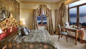 a bedroom with a bed and a desk and a window at Daru Sultan Hotels Galata in Istanbul