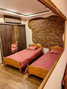 deux lits dans une chambre avec un miroir dans l'établissement Tallinna mnt Kodu, à Pärnu