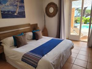 a bedroom with a bed with a view of a pool at Villa Esmeralda Adults Only in Les Issambres