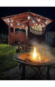 a fire pit on a table in a yard at night at Willa Górska in Karpacz