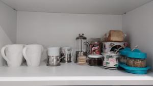 a shelf with cups and other items on it at Estudio Urbano in Santa Rosa