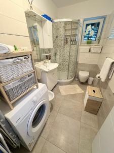 a washing machine in a bathroom with a shower at Apartment Anđelina, Split in Split +108 photos