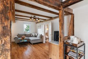 a living room with a couch and a tv at Erlebnis-Bauernhof Heimatliebe in Oberkirch
