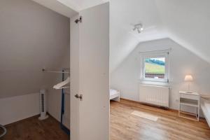a white room with a bed and a window at Erlebnis-Bauernhof Heimatliebe in Oberkirch +31 photos