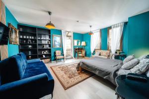 a blue room with a bed and a couch at WagnerStays BadEms Historic VillaWhirpool Billiard in Bad Ems