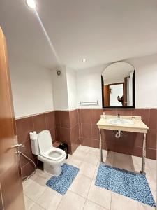 a bathroom with a toilet and a sink and a mirror at Tanger City 3 in Tangier