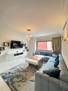 a living room with a couch and a table at Tanger City 3 in Tangier +11 photos