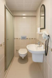 a bathroom with a toilet and a sink at Doruk Hotel & Suits in Marmaris +14 photos