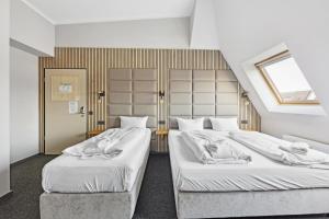 Postel nebo postele na pokoji v ubytování Hotel Comenius