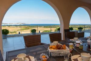 a table with food and a view of the ocean at Villa la Vista in Lumio
