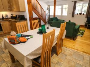a kitchen and dining room with a table and chairs at The Baler House in Hayle