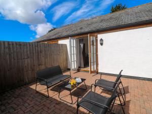 a patio with two chairs and a table at The Baler House in Hayle