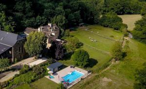 an aerial view of a large house with a swimming pool at La Ferme des Andes in Quins