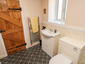 a bathroom with a sink and a toilet and a door at Chapel Hill House in Pembroke +32 photos