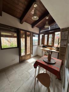 a kitchen with a table and some windows at Casa Regacens in Alquézar