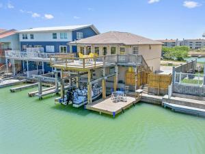 a house on a dock in the water at Waterfront Studio, Fishing Pier, Boat Slips, Pet Friendly in Port Isabel