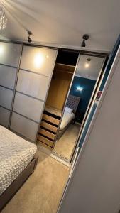 a small bedroom with a bed and a mirror at Roserin Coorie, Perth - just a few minutes walk from the city centre! in Perth