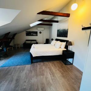 a bedroom with a white bed and a blue rug at Stekhuset B&B in Kalmar