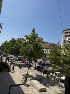 a man is riding a bike on a city street at Heart of Vlore Walk to Beach in Vlorë +1 photo