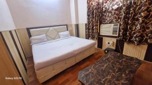 Ένα ή περισσότερα κρεβάτια σε δωμάτιο στο Hotel Asia Palace