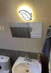a bathroom with a sink and a toilet and a light at lavista cozy chalet one bedroom in Ain Sokhna +15 photos