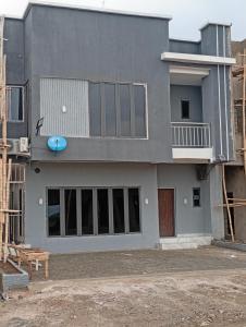 a gray house with a building under construction at Lamaisu Homes Block 3 in Abuja