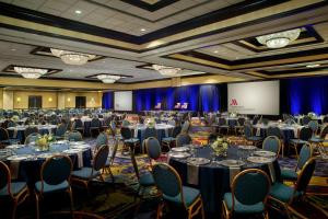 a banquet hall with tables and chairs and a stage at Atlanta Airport Marriott in Atlanta +113 photos