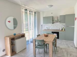 a kitchen with a wooden table and chairs in a room at San Filippo Tuscany Homes in Bagni San Filippo