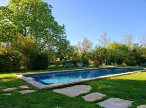 a swimming pool in the middle of a yard at Mas Notre-Dame, Adults only, situation idéale, grand jardin paisible in Grospierres