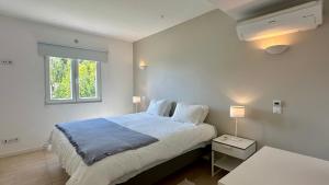a bedroom with a large bed and a window at Galo - Private Pool - 8 Guests - Albufeira in Albufeira