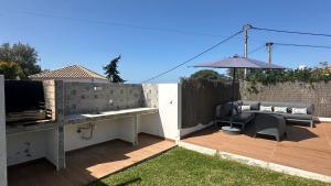 a patio with a bench and an umbrella at Galo - Private Pool - 8 Guests - Albufeira in Albufeira +20 photos