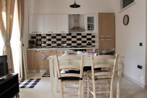 a kitchen with a table with chairs and a counter top at Lu Passittu in Norcia