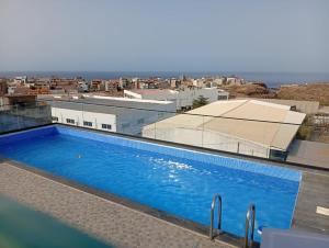 a swimming pool on the roof of a building at Maison da Praia in Praia