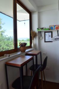 a room with two desks and a window at Rustic Tale Guesthouse in Tale