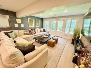 a living room with a couch and a table at Modern 3b3b Country House and Barn on quiet road in Little Compton