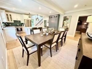 a kitchen and dining room with a wooden table and chairs at Modern 3b3b Country House and Barn on quiet road in Little Compton