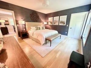 a bedroom with a bed and a table and a couch at Modern 3b3b Country House and Barn on quiet road in Little Compton