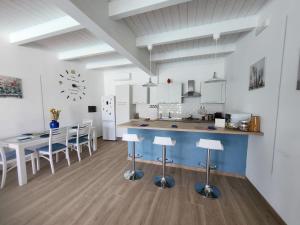 a kitchen with a blue counter and a table and chairs at Villa Celeste in Brusciano