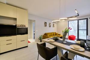 a kitchen and dining room with a table and chairs at Scandinavian Stay - Awarded Bldg - Downtown in Sofia