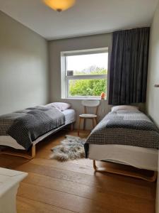 a bedroom with two twin beds and a window at City center, Tórshavn in Tórshavn