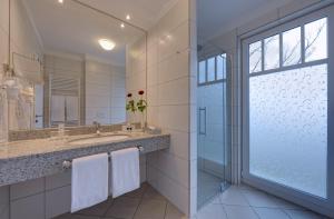 a bathroom with a sink and a mirror at Hotel Aquamarin in Kühlungsborn