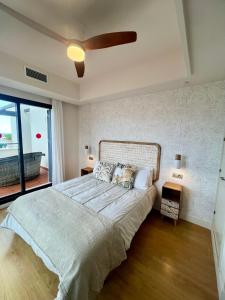 a bedroom with a large bed with a ceiling fan at SEAVIEW Luxury PENTHOUSE in Casares +32 photos