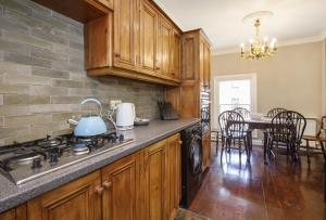 a kitchen with a stove and a table with chairs at St Wilfrid's Court in York