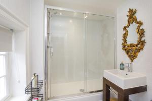 a bathroom with a shower and a sink and a mirror at St Wilfrid's Court in York +16 photos