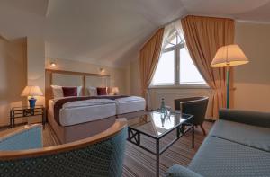 a hotel room with a bed and a table at Hotel Aquamarin in Kühlungsborn