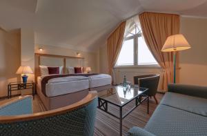 キュールングスボルンにあるHotel Aquamarinのベッドとテーブルが備わるホテルルームです。