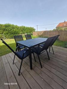 a picnic table and two chairs on a deck at Maison de village in Vesoul