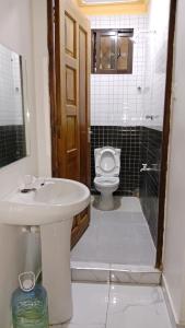 a bathroom with a sink and a toilet at VITU Fine 001 in Mombasa